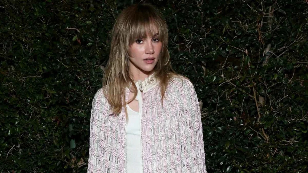 Suki Waterhouse Turns Heads in Completely See-Through Dior Cape Over Crop Top and Jeans Look