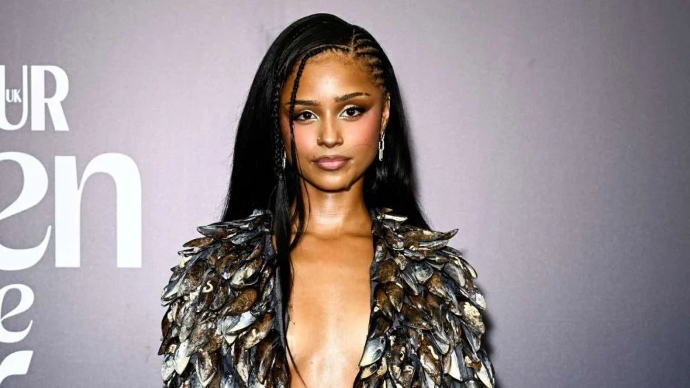 Tyla Styles Her Own Merch as a Crop Top, Pairing It with Micro Shorts and Fishnets for a Bold Fashion Statement